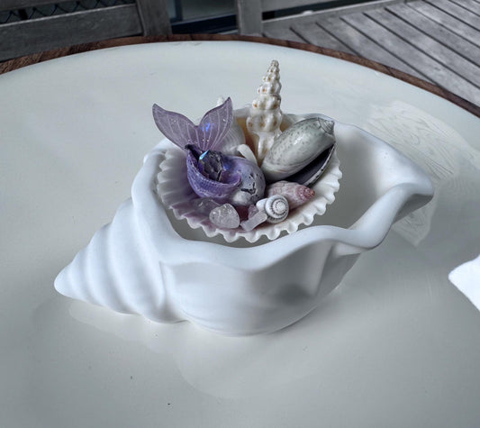 Whimsical Conch Shell featuring Seaglass, mermaids tail, precious shells and a handmade conch to rest in.