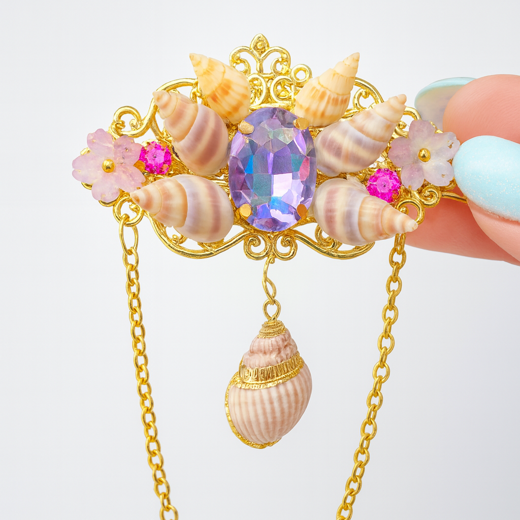 Decorative brooch with seashells, gemstones, and a gold chain on a white background