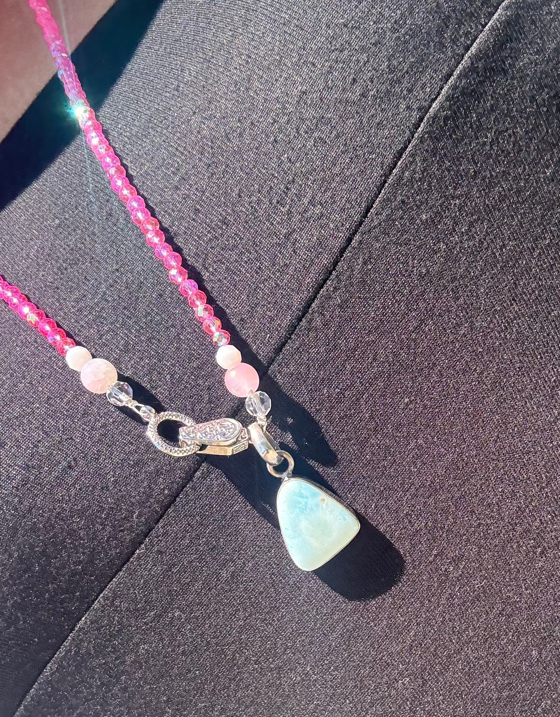 Necklace with a pendant on a dark fabric background